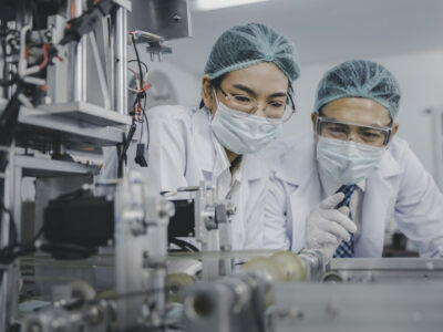 2 people in lab coats working